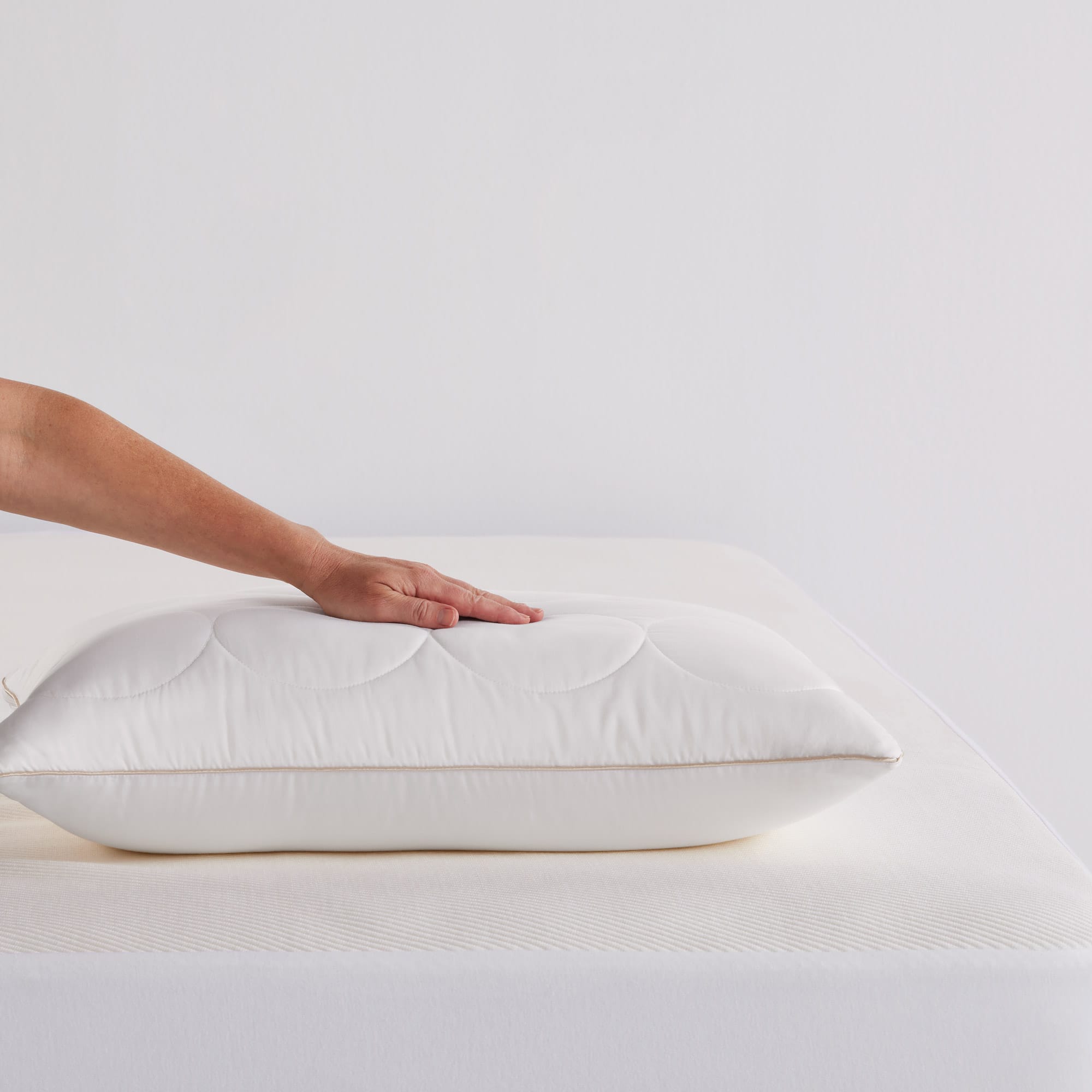 CalmComfort 7+ Pillow hand on pillow - thumbnail #1