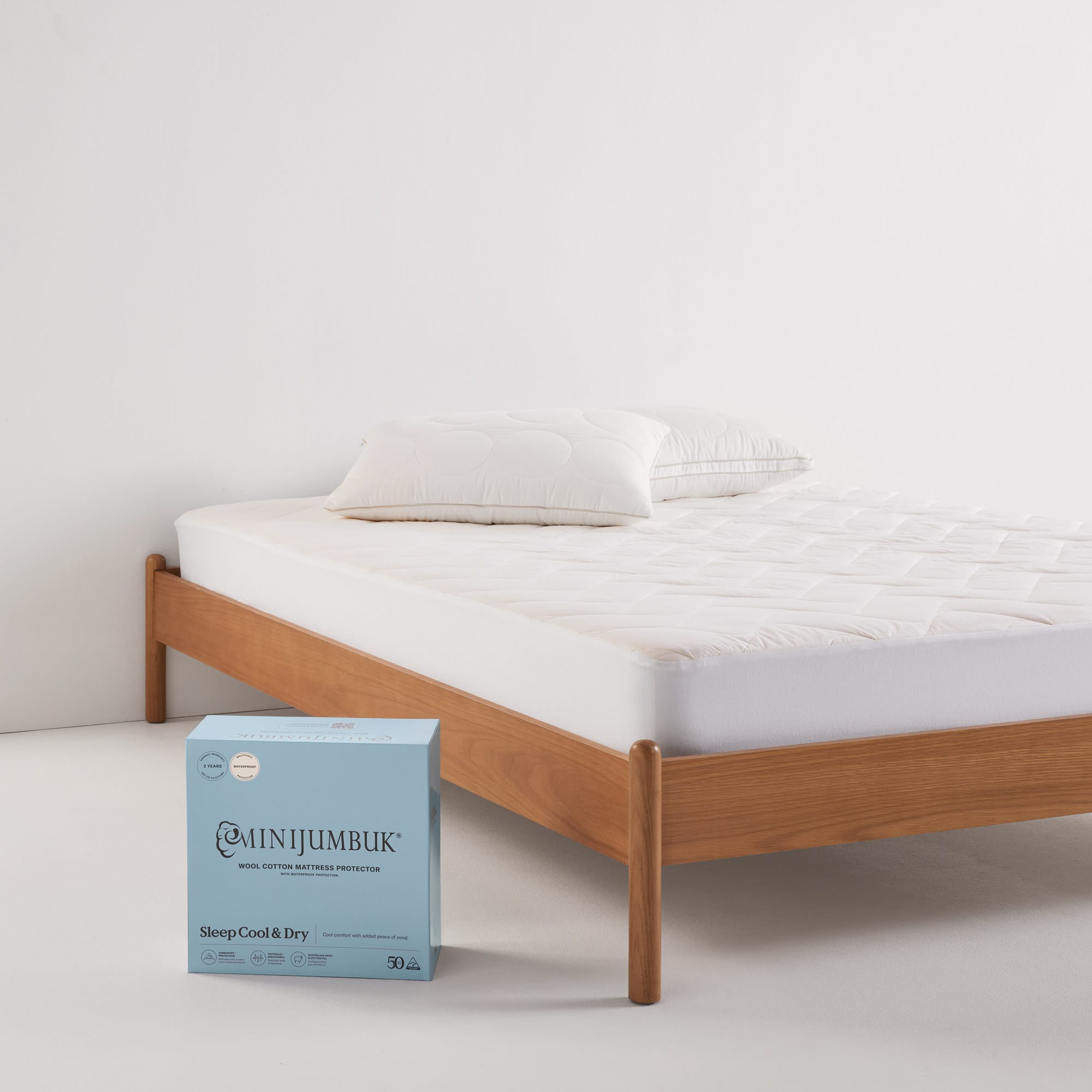 Sleep Cool Dry Mattress Protector product on bed and packaging - thumbnail #4