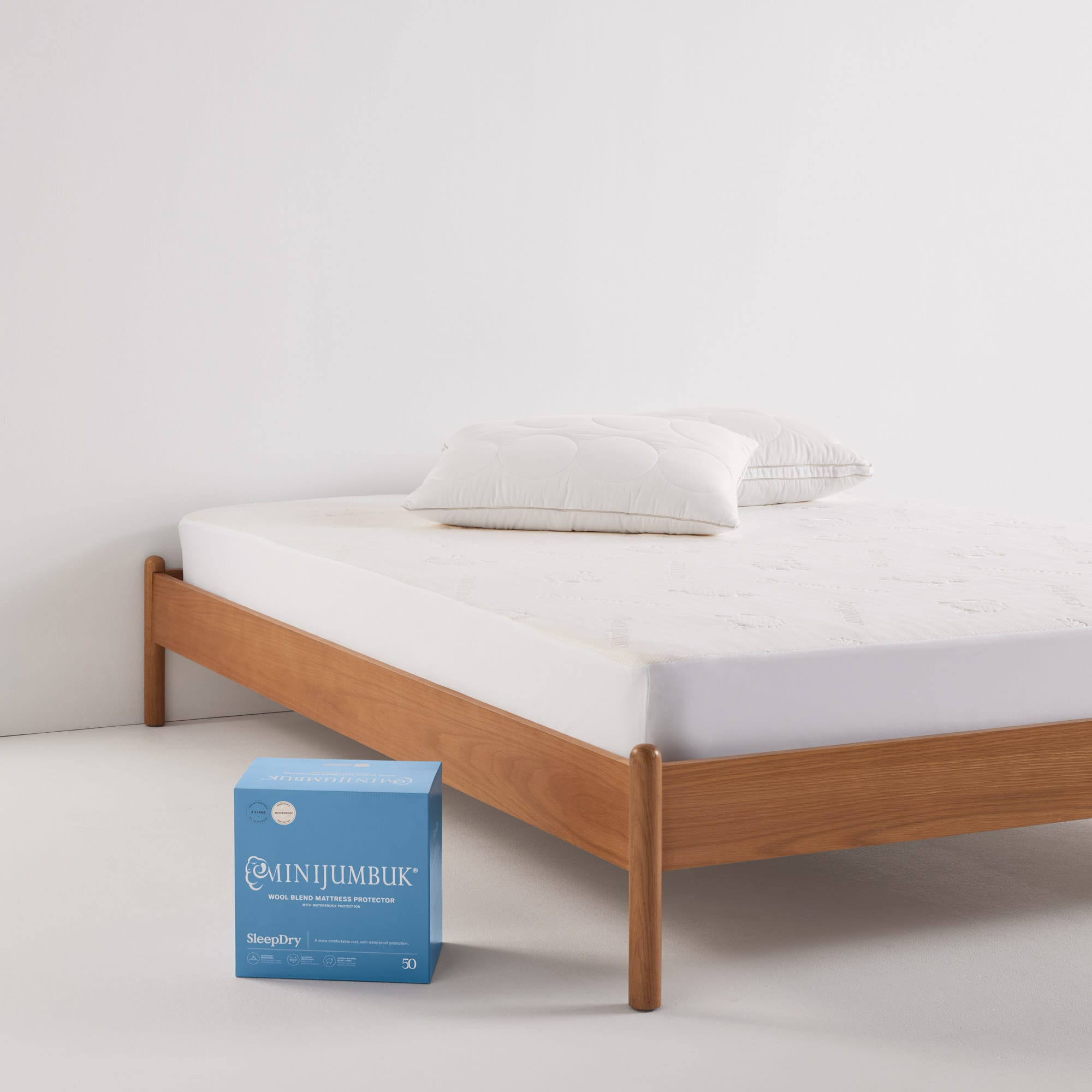 SleepDry Mattress Protector product on bed with packaging - thumbnail #7